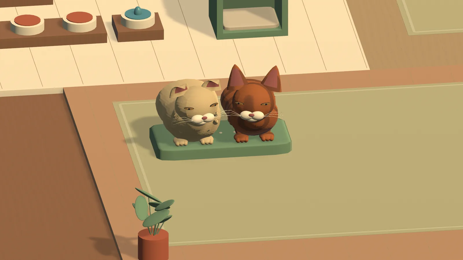 Two cats sit together on a green cushion.